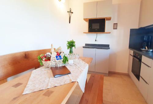 a small kitchen with a table with a cross on it at Springerhof in Schechen