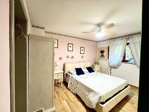 a bedroom with a bed and a ceiling fan at Villa Maria Grazia in Lucca