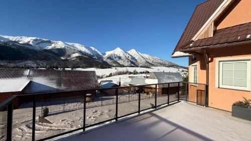 a balcony with a view of snow covered mountains at Penzión Soňa in Ždiar