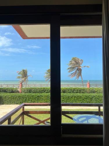 a view of the beach from a window at Kariri Beach Residence in Caucaia