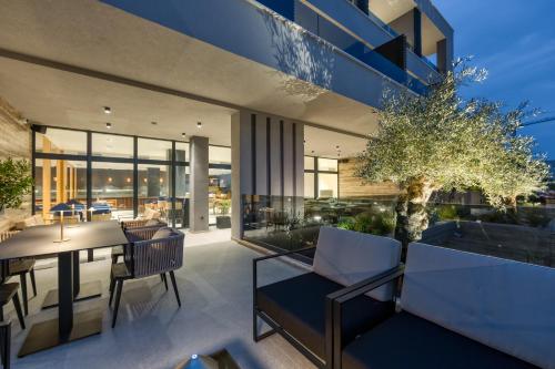 a house with a dining area and a table at Level 5 Rovinj - Adults Only in Rovinj