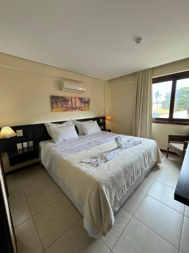 a bedroom with a large bed in a room at Kariri Beach Residence in Caucaia