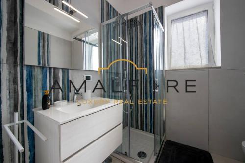 a bathroom with a sink and a mirror at Casa Angelina in Conca dei Marini