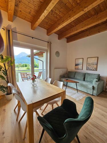 a living room with a table and chairs and a couch at Apartment Sommer am Faaker See in Faak am See