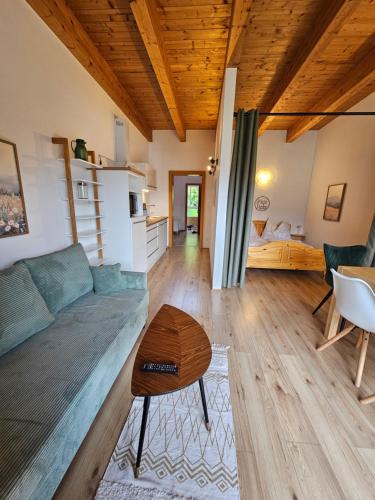 a living room with a couch and a table at Apartment Sommer am Faaker See in Faak am See