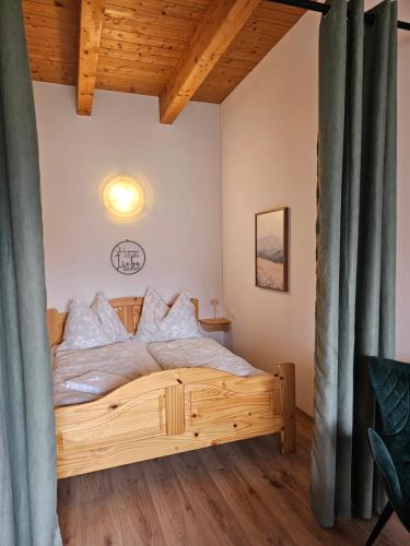 a bedroom with a wooden bed in a room at Apartment Sommer am Faaker See in Faak am See