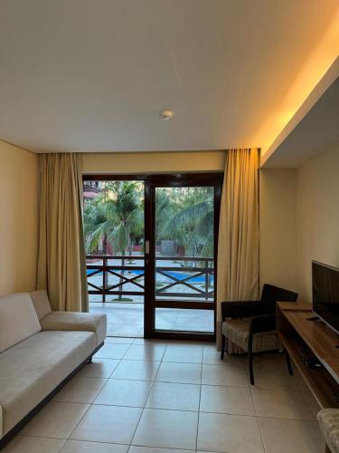 a living room with a couch and a television at Kariri Beach Residence in Caucaia