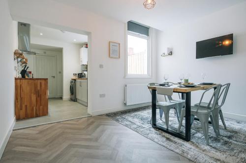a kitchen and dining room with a table and chairs at 3 Bedroom House Workstays UK in Middlesbrough