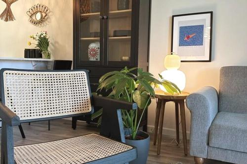 a living room with a couch and a table with a plant at Inbal's suite, Caesarea in Caesarea