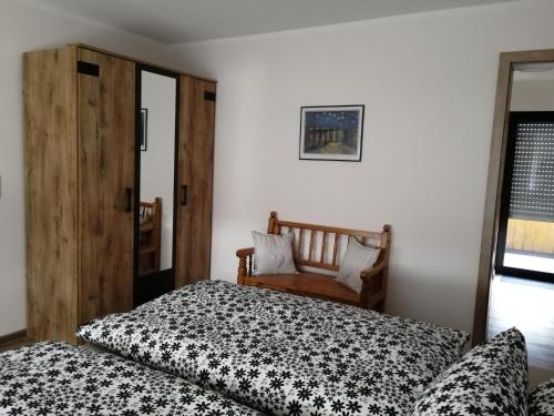 a bedroom with two beds and a wooden door at Eifelferienwohnungen "Familie Saxler" in Bereborn