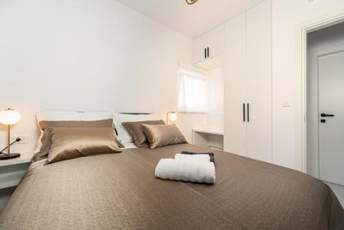 a large bed in a white room with at Villa Adria Maria 2 in Privlaka