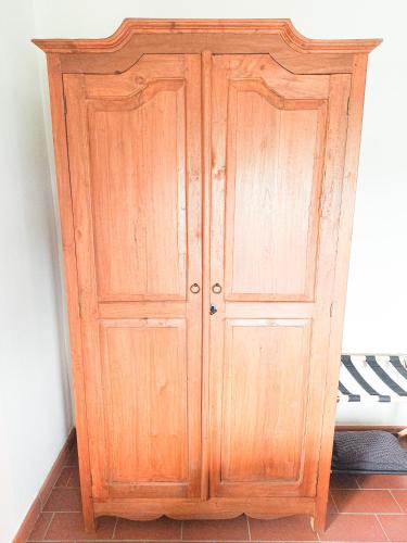 a wooden cabinet in the corner of a room at Dimora Gentile BnB in Castiglione del Lago