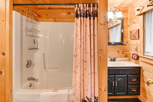 a bathroom with a shower and a tub and a sink at Lakefront Adirondacks Home Lake George Oasis! in Huletts Landing
