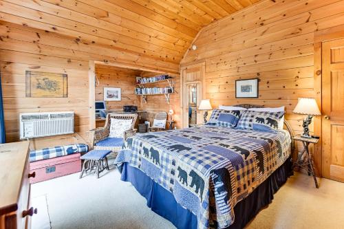 a bedroom with a bed in a log cabin at Lakefront Adirondacks Home Lake George Oasis! in Huletts Landing