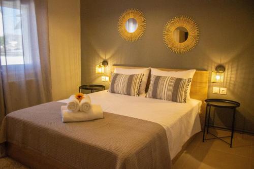 a bedroom with a bed with a towel on it at Annis House in Epanomi