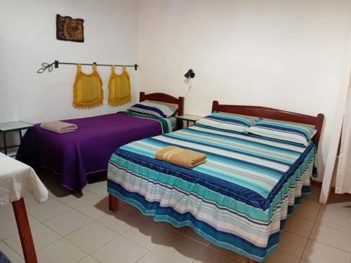 a bedroom with two beds with towels on them at Landhaus Samaipata in Samaipata