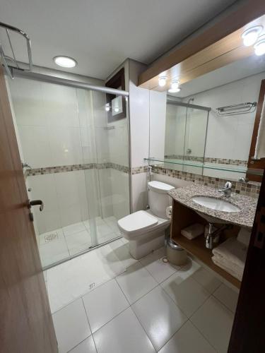 a bathroom with a shower and a toilet and a sink at Kariri Beach Residence in Caucaia
