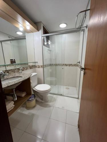 a bathroom with a shower and a toilet and a sink at Kariri Beach Residence in Caucaia