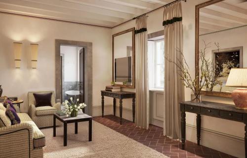 a living room with a couch and a television at Villa San Michele, A Belmond Hotel, Florence in Fiesole