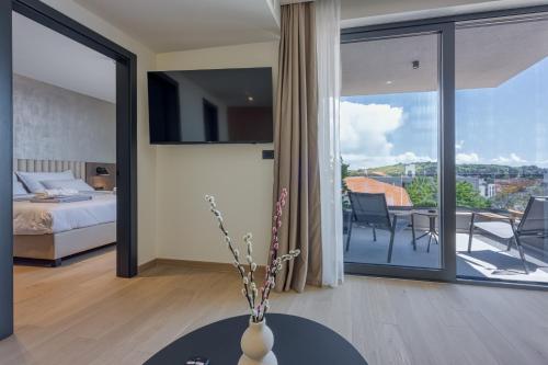 a bedroom with a bed and a balcony with a view at Level 5 Rovinj - Adults Only in Rovinj
