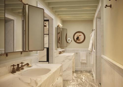 a white bathroom with a sink and a mirror at Villa San Michele, A Belmond Hotel, Florence in Fiesole