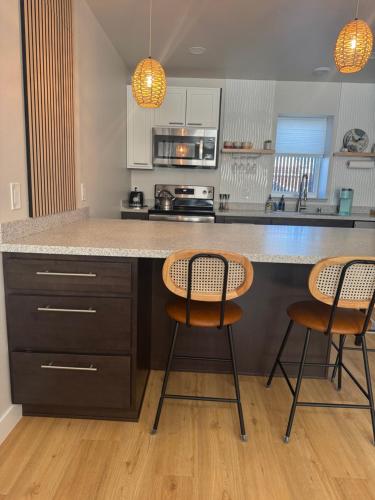 a kitchen with two chairs and a counter top at DWELL in Alaska Apartment h in Fairbanks