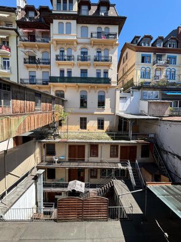 an apartment building with stairs in front of it at Hotel Parc & Lac in Montreux
