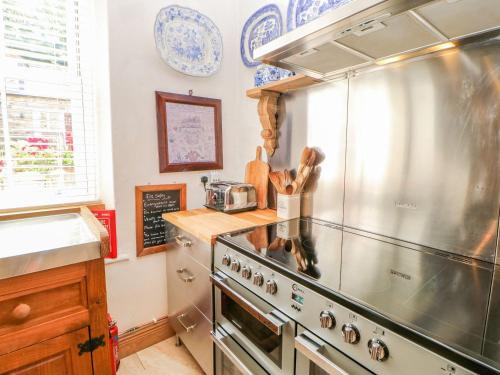 a kitchen with a stainless steel stove top oven at Shaftoe Mews in Hexham
