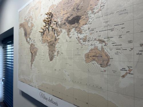 a large map of the world on a wall at Cozy STAY in City Center in Telšiai