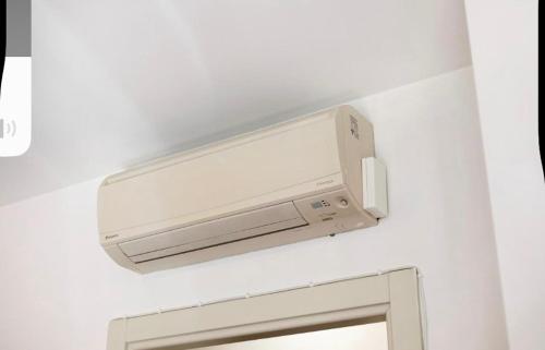 a bathroom with a wall mounted air conditioner at Golf Resprt il Feudo in Serravalle dʼAsti
