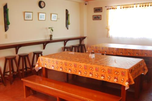 a restaurant with two tables and a bar at Las Mercedes Finca Cafetera in Cumaca