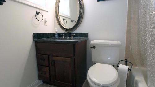 un bagno con un water, un lavandino e uno specchio di Broadway Beach Unit 1 a Cape May