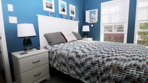 a bedroom with a bed and a blue wall at 202 Ocean Unit 6 in Cape May Point