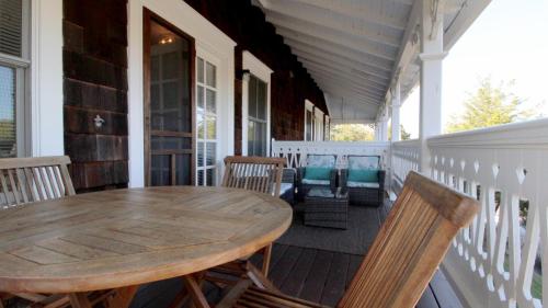 a wooden table and chairs on the porch of a house at 202 Ocean Unit 6 in Cape May Point