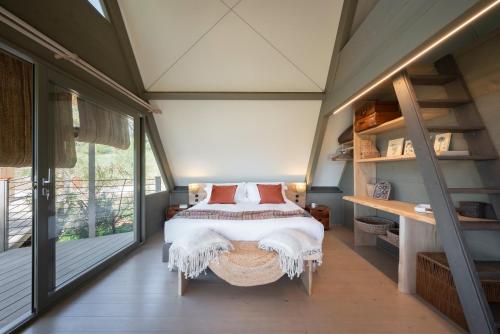 a bedroom with a bed and a large window at Boutique Hotel Poggio ai Santi - Adults Only in San Vincenzo