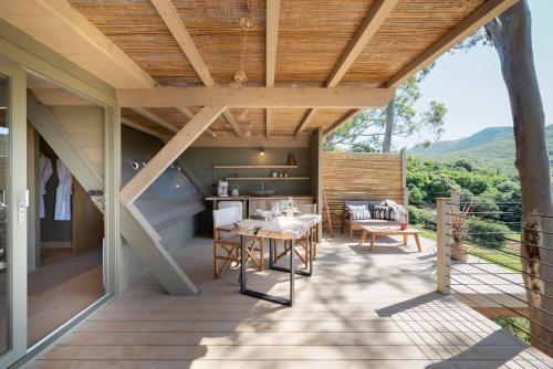 an outdoor kitchen with a table and chairs on a patio at Boutique Hotel Poggio ai Santi - Adults Only in San Vincenzo
