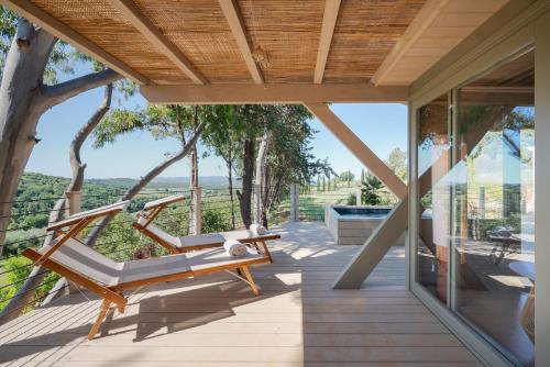 a porch with a hammock on a house at Boutique Hotel Poggio ai Santi - Adults Only in San Vincenzo