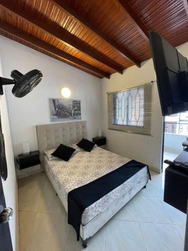 a bedroom with a bed and a flat screen tv at Hotel San Pablo boutique H9 in Medellín