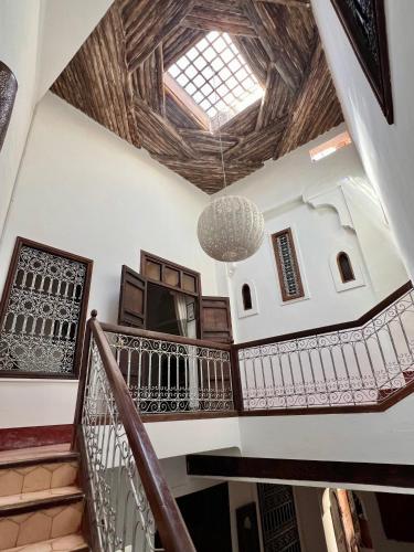 a staircase in a home with a wooden ceiling at Riad Jnan El Cadi in Marrakech