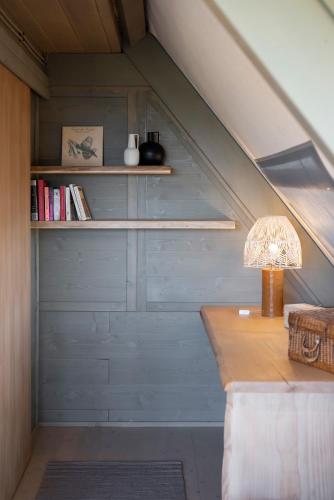 an attic room with a table and a lamp at Boutique Hotel Poggio ai Santi - Adults Only in San Vincenzo