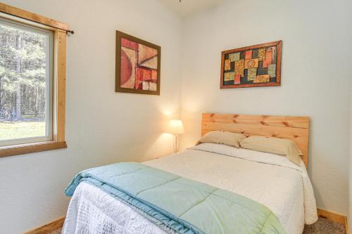 a bedroom with a bed and a window at Townsend Cottage on UTV and Snowmobile Trail! in Townsend