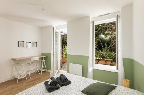 une chambre avec un lit, un bureau et une fenêtre dans l'établissement T2 Cotriade, à Brest