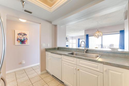 a kitchen with a sink and a counter top at Beachfront New Smyrna Condo: 1 Mi to Flagler Ave in New Smyrna Beach
