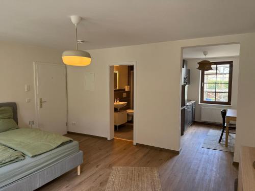 a bedroom with a bed and a living room at 1- Zimmerappartment in Geisenheim