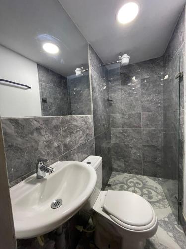 a bathroom with a toilet and a sink at Hotel San Pablo boutique H9 in Medellín
