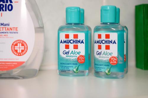 three bottles of cleaning products sitting on a counter at A Casa di Lu' Elegant Rooms in Monterotondo