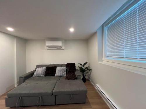 un dormitorio con una cama y una ventana en Cozy 2 bedrooms Suite Near Calgary Airport Sleeps 6, en Calgary