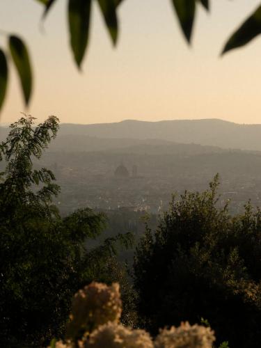 a view of a city from a hill with trees at Villa San Michele, A Belmond Hotel, Florence in Fiesole