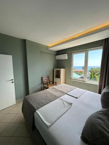 a bedroom with a large bed and a window at Havana Apart Hotel in Alanya