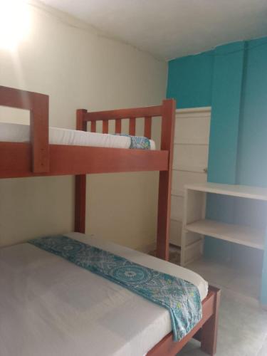 a bedroom with two bunk beds in a room at AquaMarina Hostal in Tolú